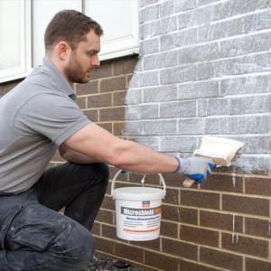 Man applying masonry waterproofing cream