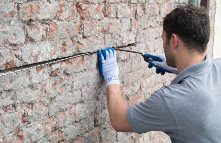 Crack stitching a wall with helical bars