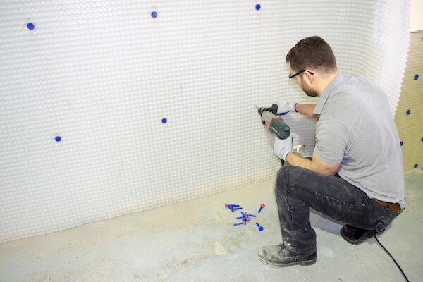 Drilling brick plugs into basement membrane