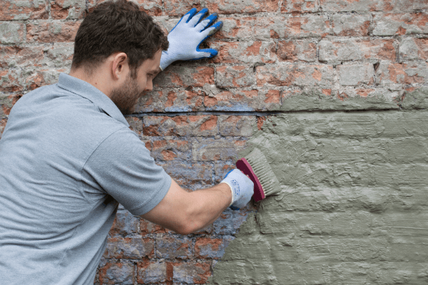 Damp proofing tanking slurry being applied