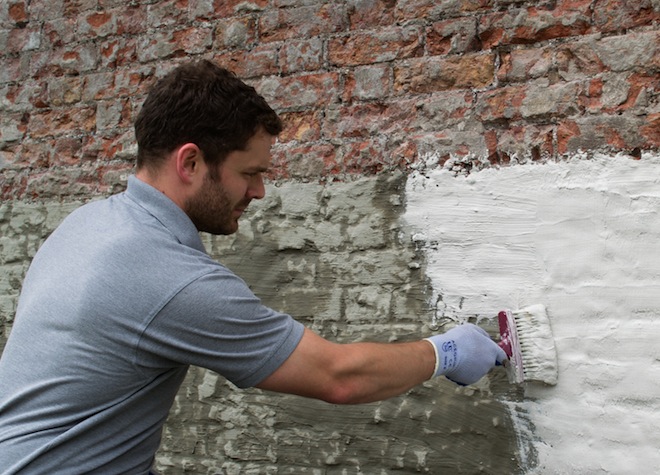 applying tanking slurry in basement