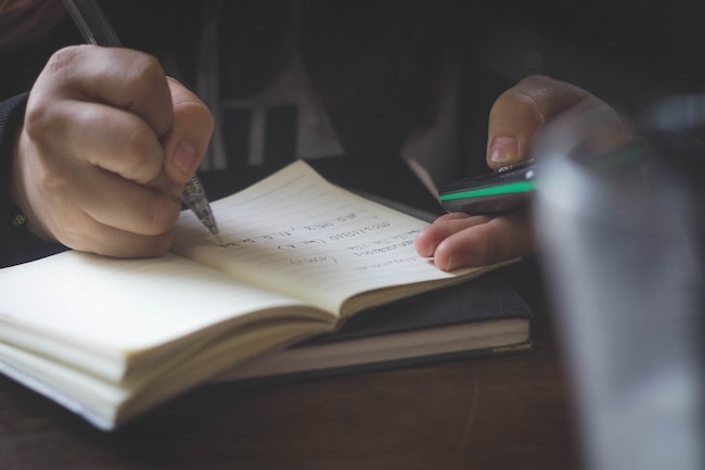 taking notes on a basement waterproofing project